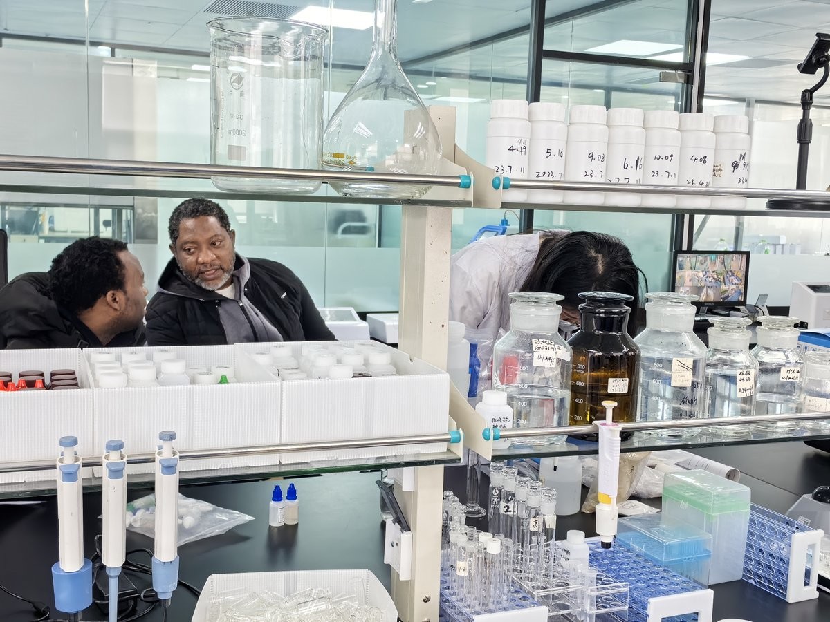 Reagent bottles and glassware prepared for soil nutrient analyzer operator training