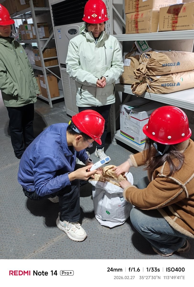 Quality control staff using handheld Raman spectrometer during on-site training at pharmaceutical plant