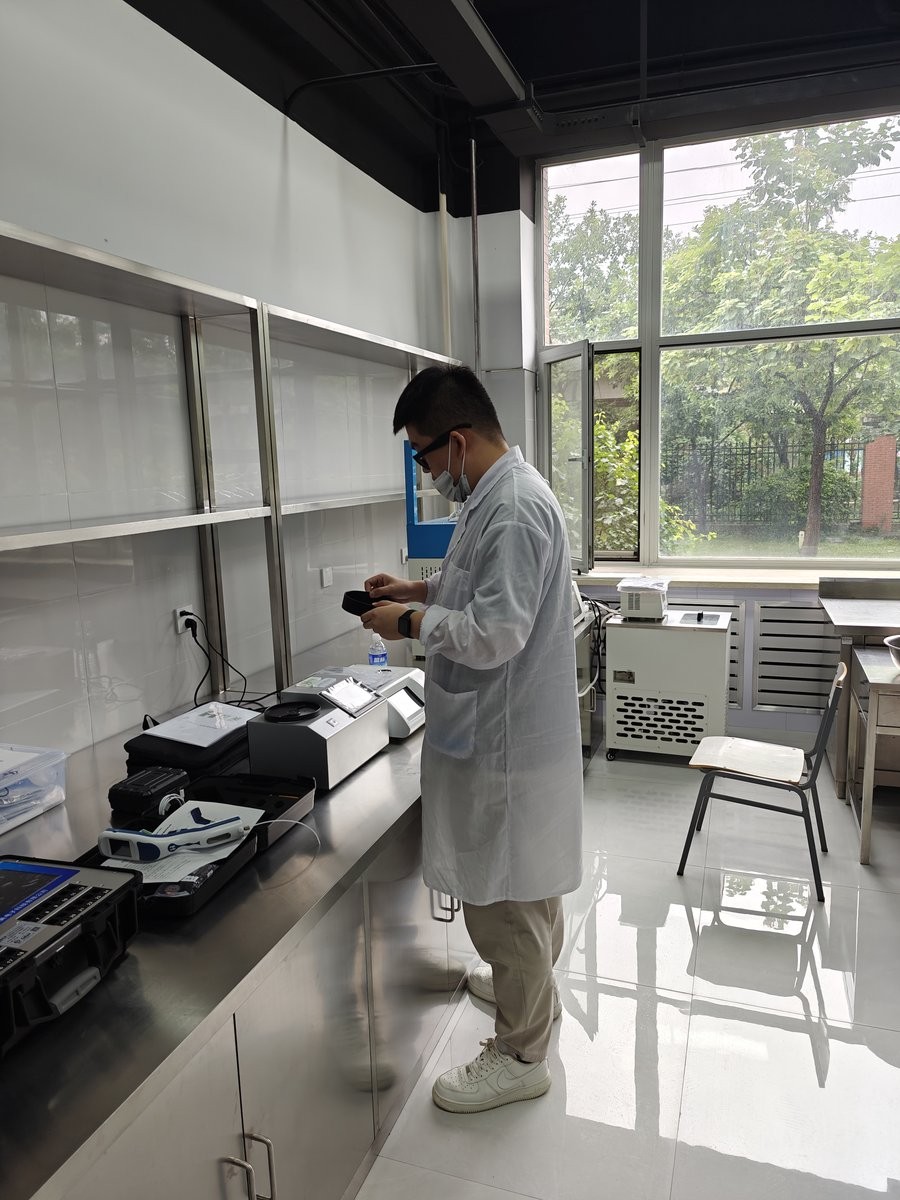 Laboratory technician operating HM-GP200 grain analyzer during training session