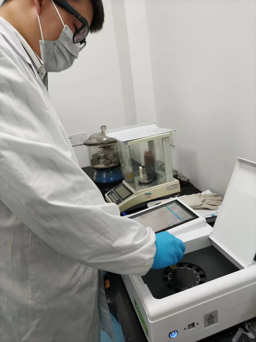Technician operating HM-GW rice freshness meter touchscreen in laboratory