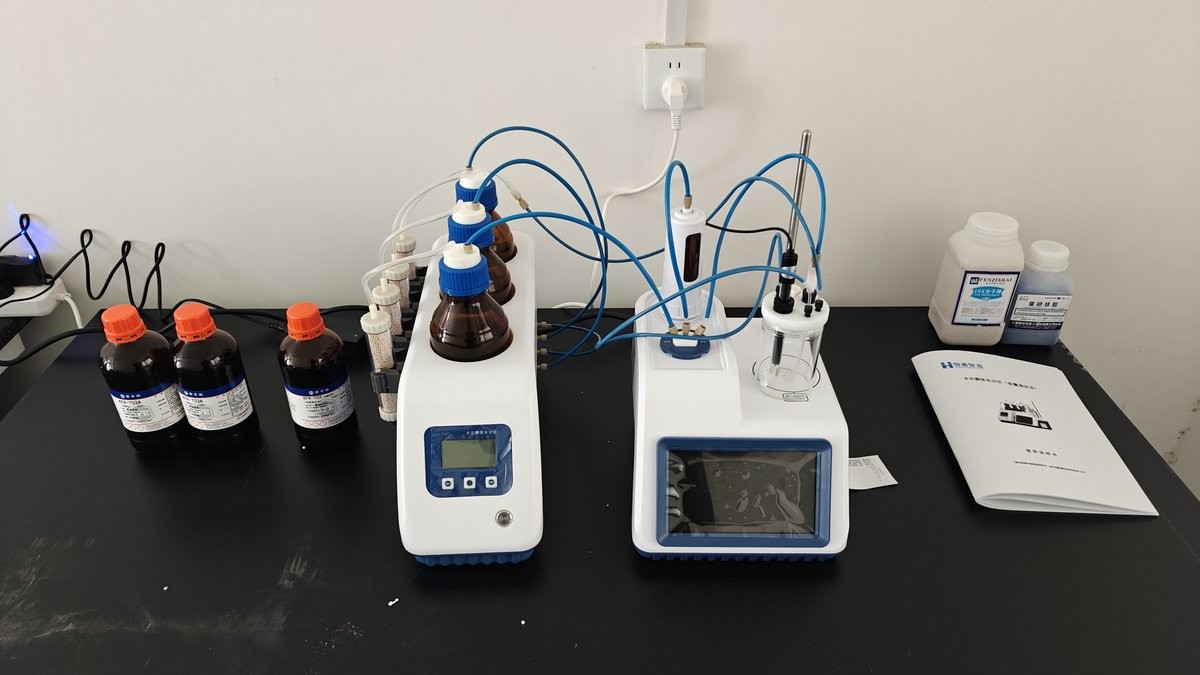 Karl Fischer moisture titrator and reagents on laboratory bench at rice seed farm