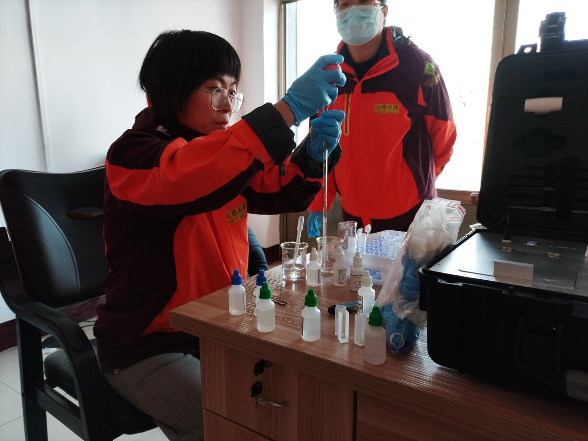 Staff member preparing soil reagent solution during HM-GT5 hands-on training