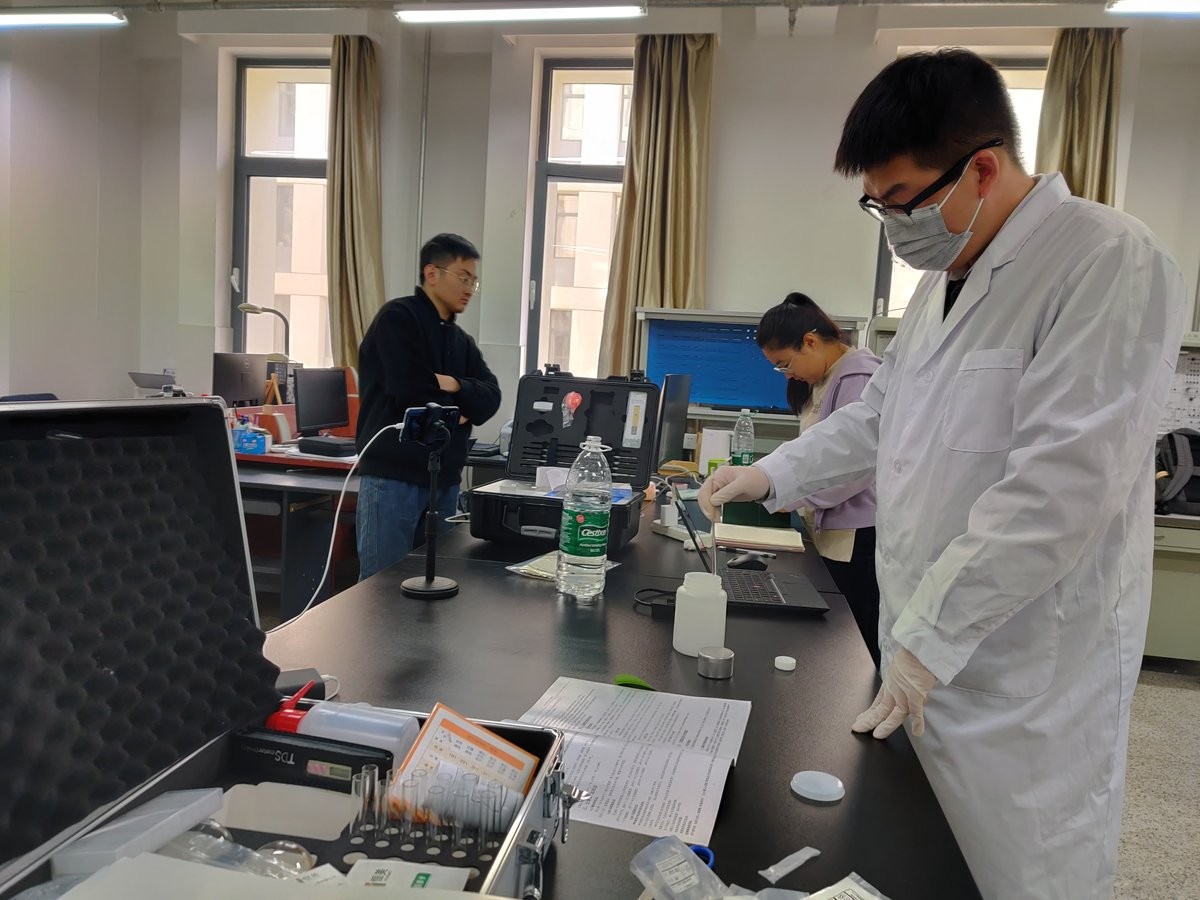 HM-GT4 instrument case opened during university training with accessories laid out on the bench