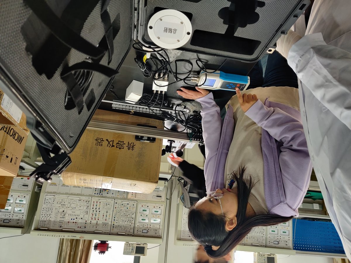 University student demonstrating a handheld soil detector during the training session