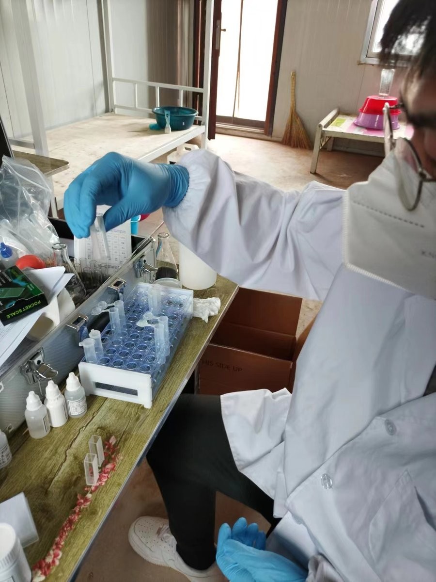 Instructor demonstrating proper test tube handling technique during HM-GT4 soil analysis training session