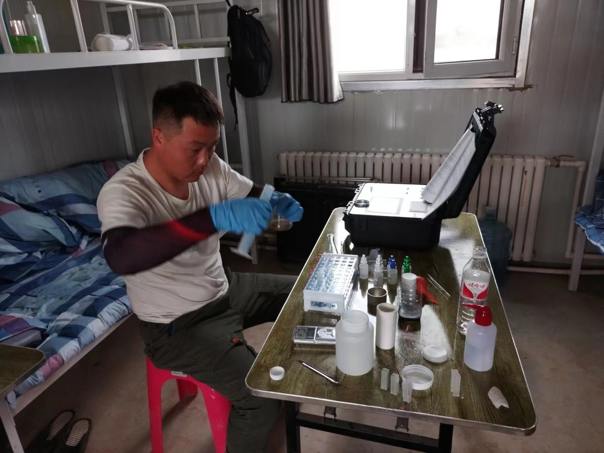Trainee mixing soil extract solution during HM-GT4 hands-on training at Xuechuan Agriculture Group portable field laboratory