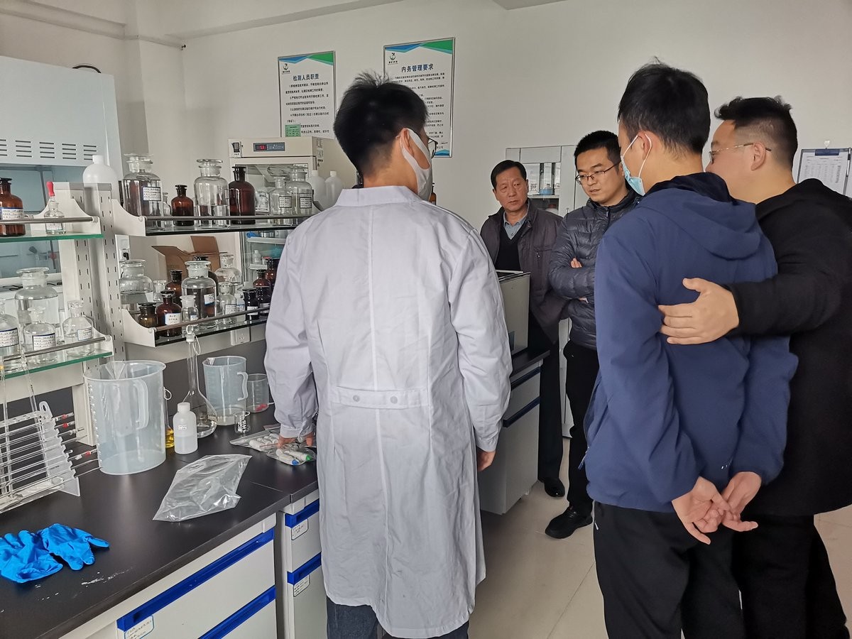 Group discussion during HM-ZSD soil heavy metal detector training at Puyang Environmental Monitoring Centre with staff gathered around equipment
