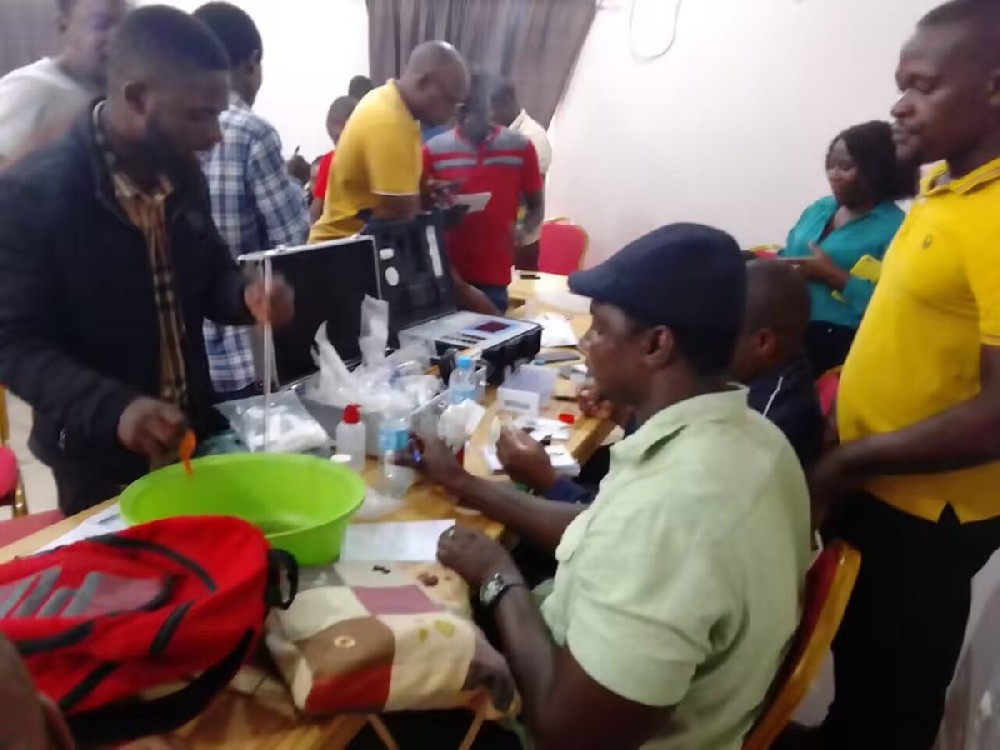 Mozambican trainees practising hands-on soil nutrient analyzer operation during training